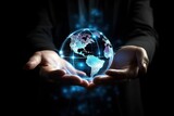 Hand holding touching glowing blue earth hologram on a dark black background. Business and innovative technology concept