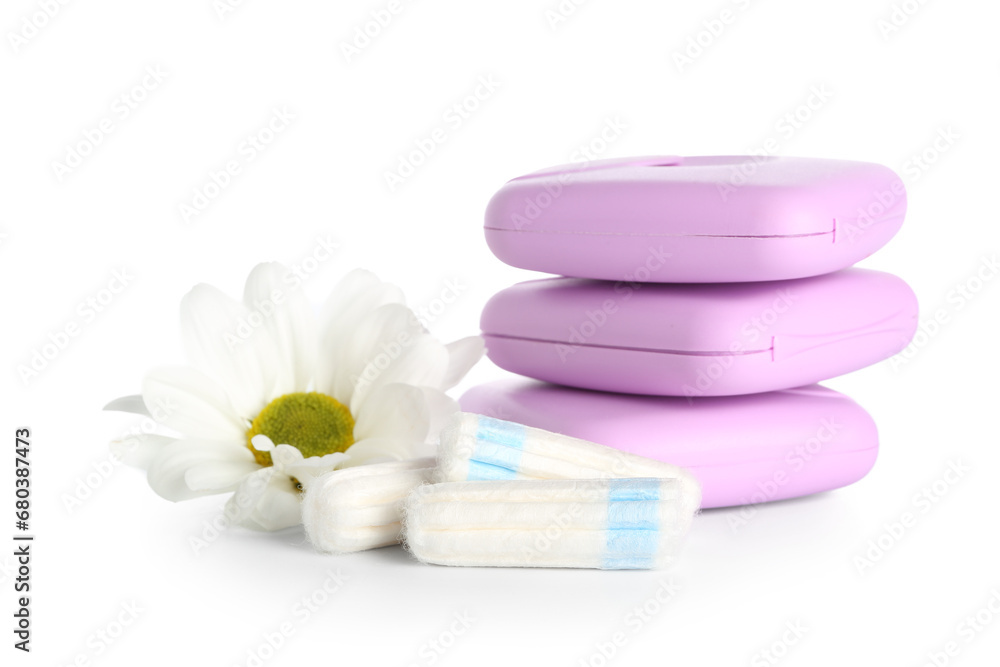 Menstrual tampons, storage boxes and chamomile flower on white background Menstrual tampons, storage boxes and chamomile flower on white background