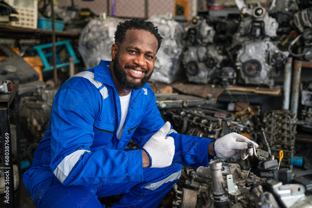 Portrait of man auto mechanic working at car repair shop with looking at camera. Portrait of man auto mechanic working at car repair shop with looking at camera.