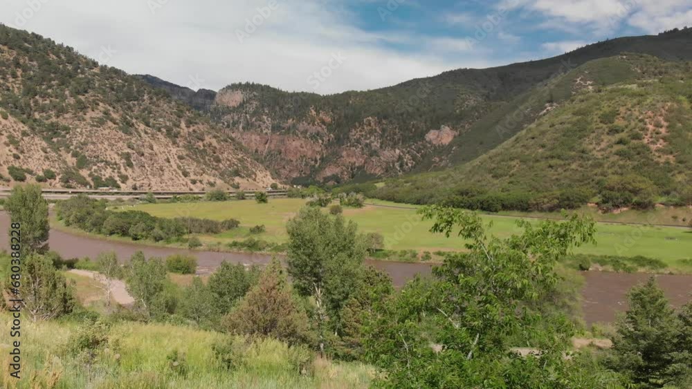 Scene capturing natural environment around Colorado river, near Moab. Landscape with trees in the riverbanks, adding a touch of green to the warm hues of the desert surroundings. Scene capturing natural environment around Colorado river, near Moab. Landscape with trees in the riverbanks, adding a touch of green to the warm hues of the desert surroundings.