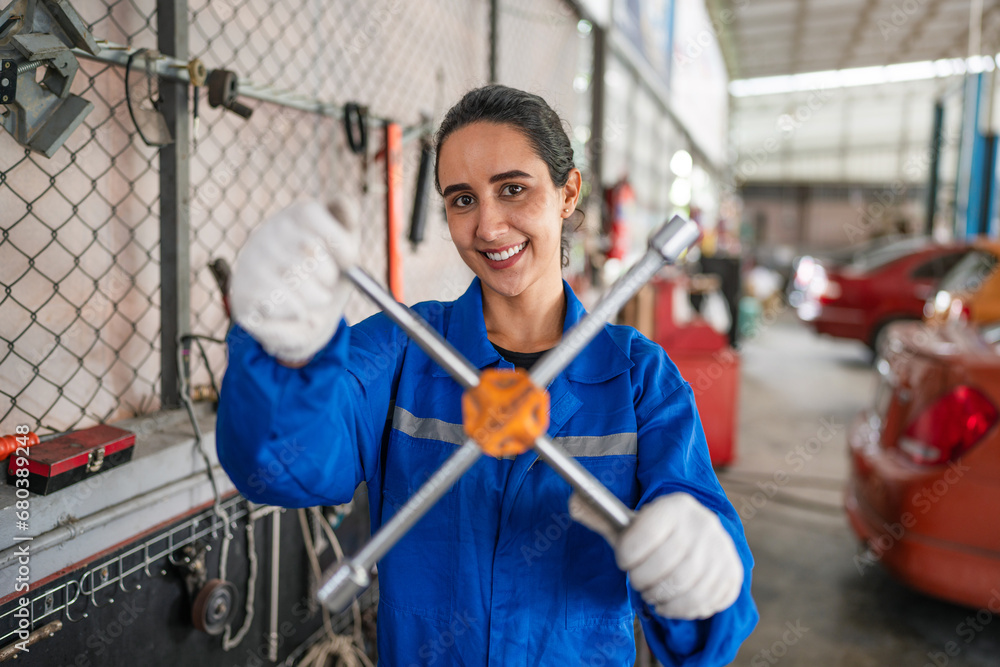 Portrait of woman auto mechanic working at car repair shop with looking at camera. Portrait of woman auto mechanic working at car repair shop with looking at camera.