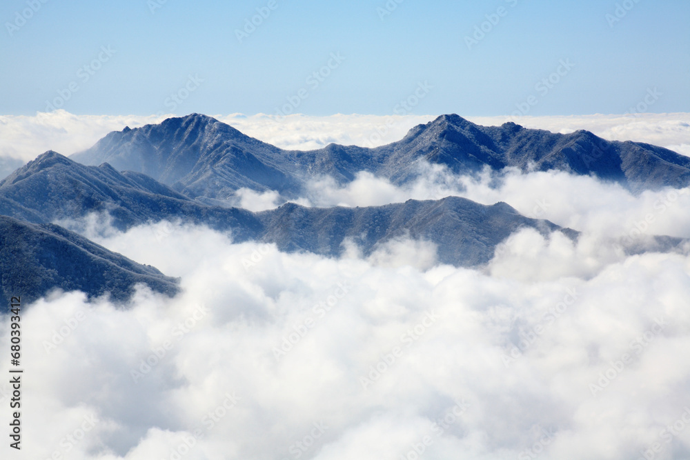 a winter mountain with clouds