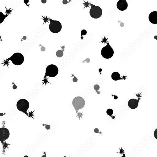 Seamless vector pattern with bomb symbols, creating a creative monochrome background with rotated elements. Vector illustration on white background