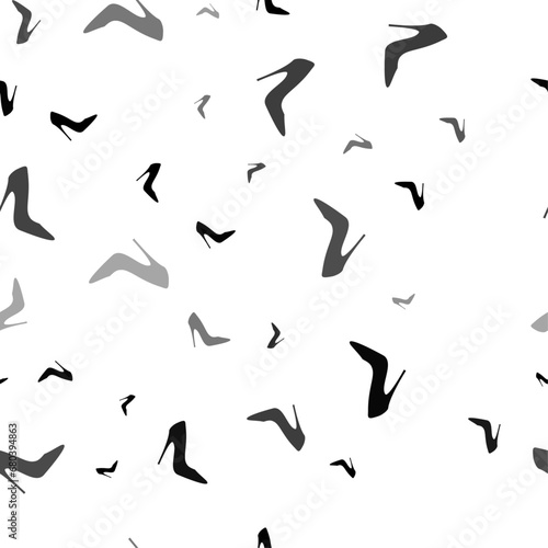 Seamless vector pattern with High heel shoe symbols, creating a creative monochrome background with rotated elements. Vector illustration on white background