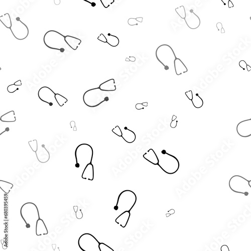 Seamless vector pattern with stethoscope symbols, creating a creative monochrome background with rotated elements. Vector illustration on white background