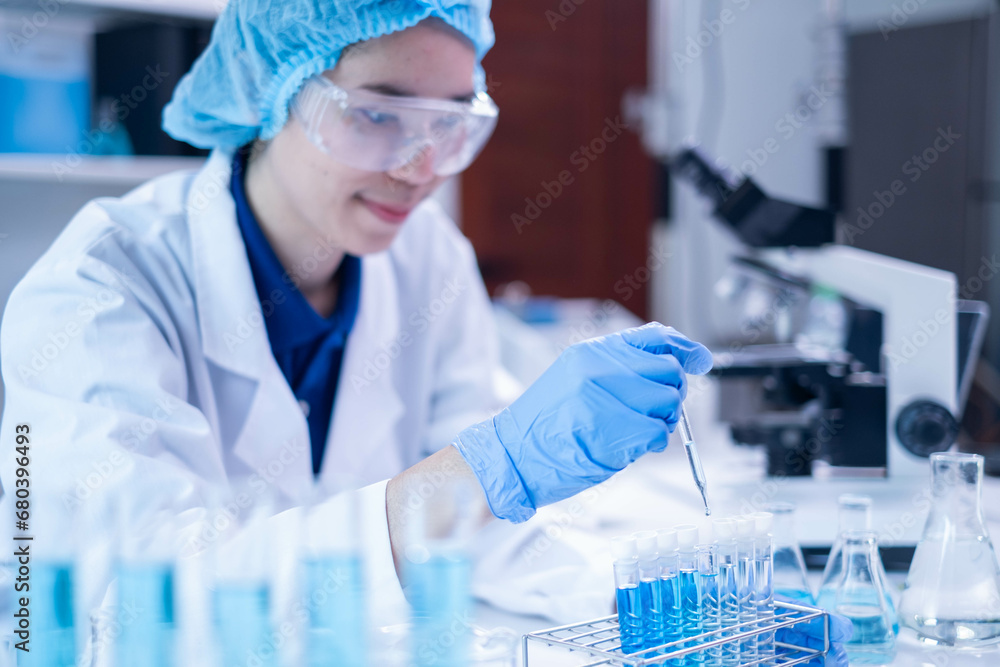 Professional scientist chemist technician analysis research experiment virus blue liquid pipette glass test tube equipment in hospital laboratory, woman doctor white lab coat medical research develop Professional scientist chemist technician analysis research experiment virus blue liquid pipette glass test tube equipment in hospital laboratory, woman doctor white lab coat medical research develop
