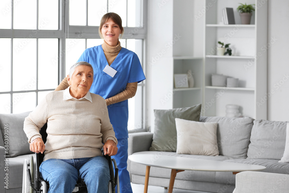 Senior woman in wheelchair with caregiver at home Senior woman in wheelchair with caregiver at home