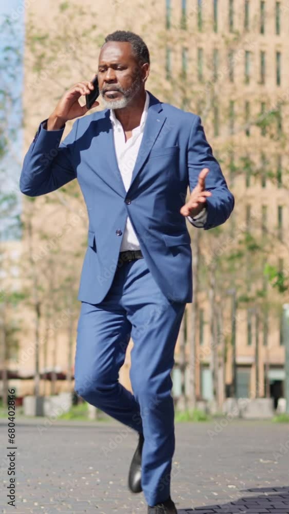 African businessman start to run while talking to the phone African businessman start to run while talking to the phone