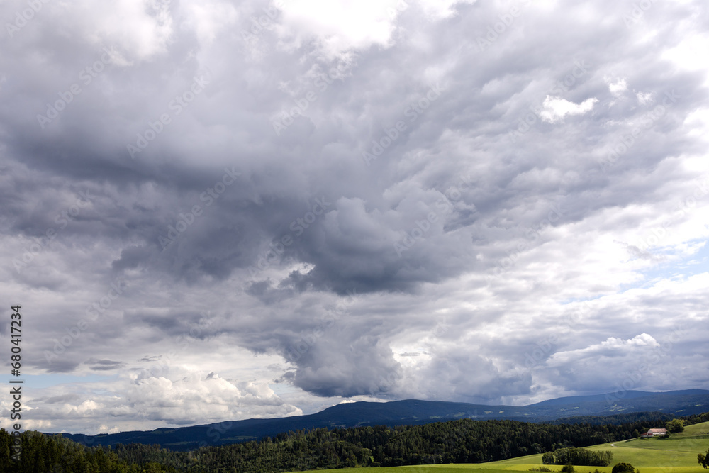 Cloudy stormy sky over hilly terrain