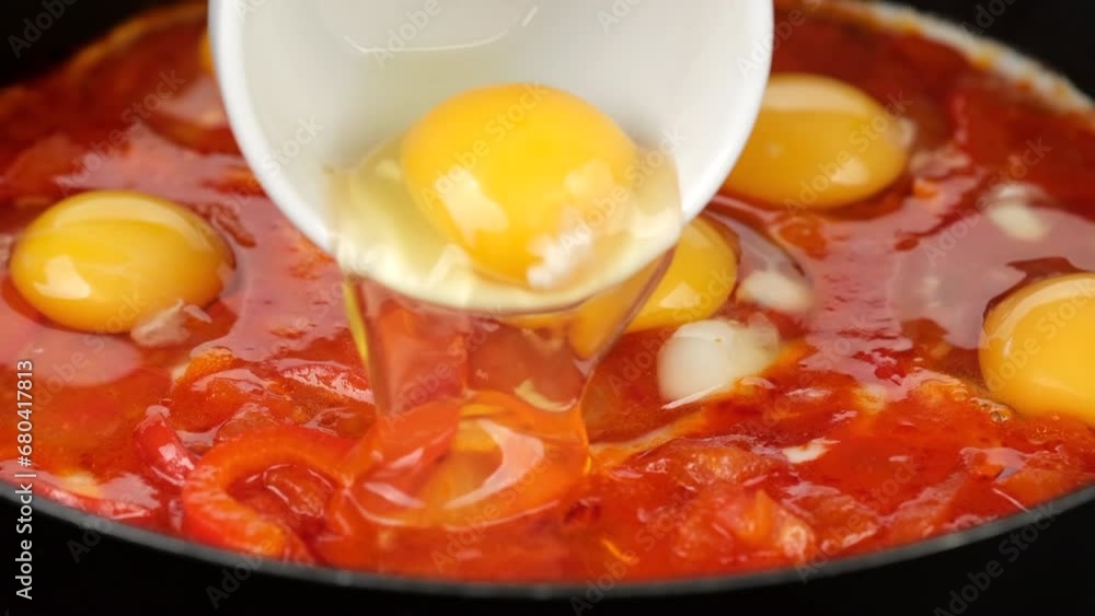 Cooking traditional Shakshuka in pan, close up Cooking traditional Shakshuka in pan, close up