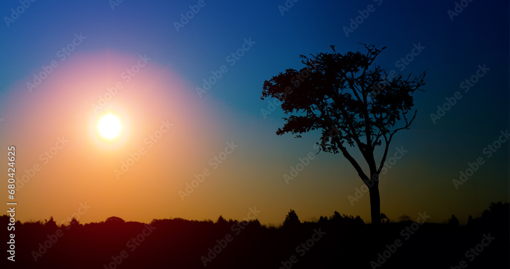 Tranquil sunset over remote rural landscape with panoramic view.