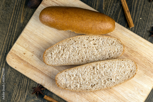 fresh wheat bread with bran on the cutting board photo