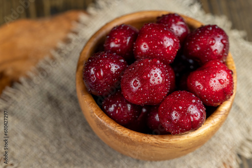 covered with drops of water ripe red cherries on the table