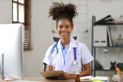 Portrait of a smiling female doctor looking at the camera in a hospital office or clinical examination room.