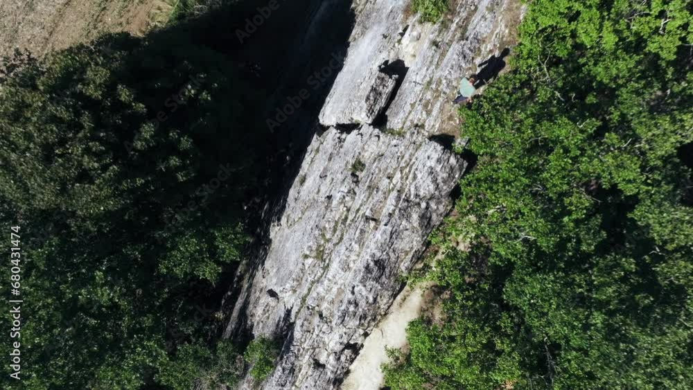 View of a bird following person hiking over Les Roches climbing site in Crest, aerial top shot view. Drôme, Outdoor and recreation activities concept. View of a bird following person hiking over Les Roches climbing site in Crest, aerial top shot view. Drôme, Outdoor and recreation activities concept.