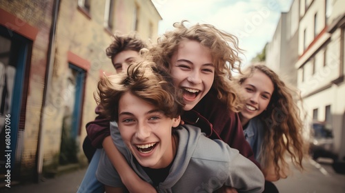 A group of cheerful diverse teenage friends enjoying a playful moment outside their school, with one giving another a piggyback ride, embodying the spirit of unity and strong friendship.