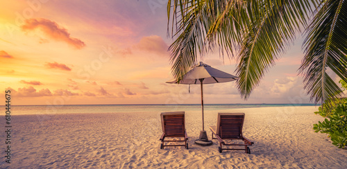 Amazing beach. Romantic chairs umbrella on sandy beach palm tree leaves, sun sea sky. Summer holiday, couples vacation. Love happy tropical landscape. Tranquil island coast relax beautiful landscape © icemanphotos