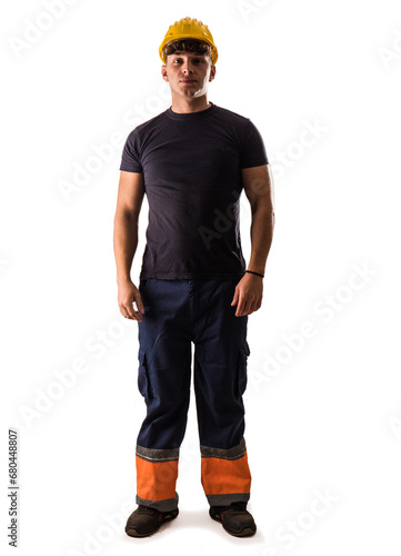 A young man wearing a hard hat and overalls, isolated on white in studio shot. Full length