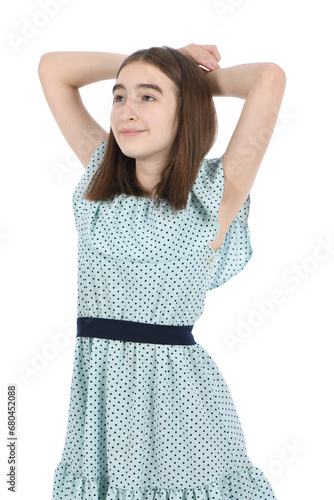 Young beautiful girl in a dress with polka dots on a white background. © Akova