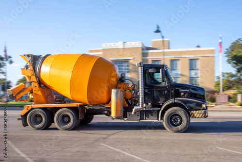 concrete mixer truck at the Main street on the way to the construction site photo