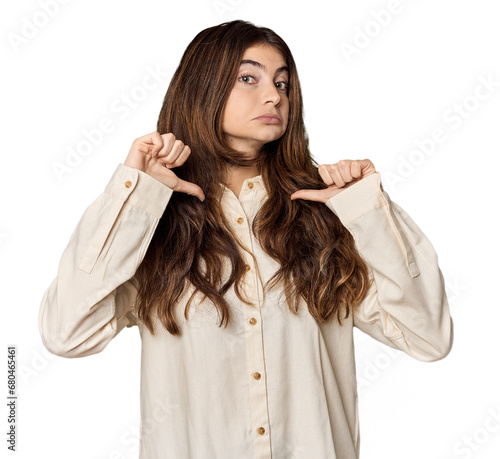 Young Caucasian woman in studio setting feels proud and self confident, example to follow.