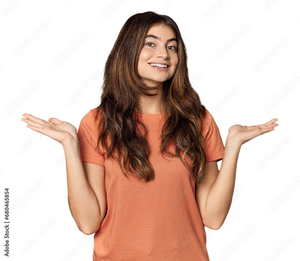 Young Caucasian woman in studio setting makes scale with arms, feels happy and confident. Young Caucasian woman in studio setting makes scale with arms, feels happy and confident.