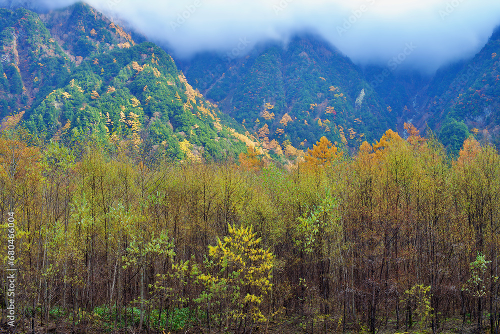 Kamikochi National Park in the Northern Japan Alps of Nagano Prefecture, Japan. Beautiful mountain in autumn leaf and Azusa river Kamikochi National Park in the Northern Japan Alps of Nagano Prefecture, Japan. Beautiful mountain in autumn leaf and Azusa river