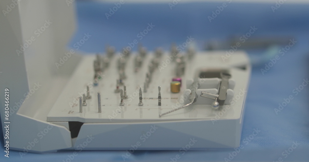 Doctor's hands with a working tool. Preparation and process of dental treatment. Dental instrument in the office of a modern dentist. Close-up in 4K, UHD Doctor's hands with a working tool. Preparation and process of dental treatment. Dental instrument in the office of a modern dentist. Close-up in 4K, UHD