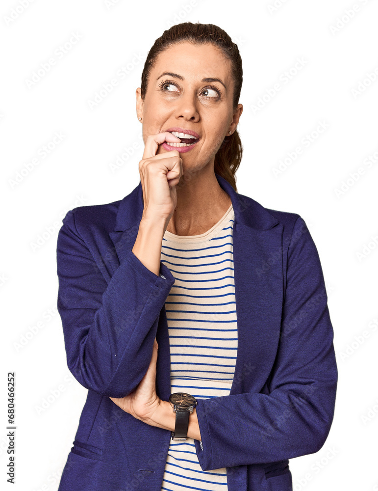 Middle-aged female entrepreneur in studio relaxed thinking about something looking at a copy space. Middle-aged female entrepreneur in studio relaxed thinking about something looking at a copy space.
