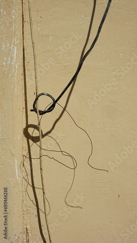 Electric cable on the wall of the house, closeup of photo.Space  background using put text or document