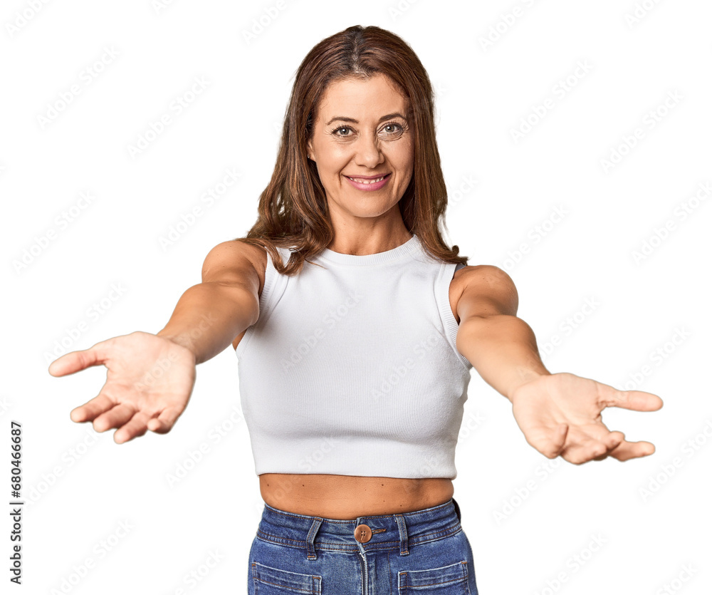 Middle-aged woman portrait in studio setting showing a welcome expression. Middle-aged woman portrait in studio setting showing a welcome expression.