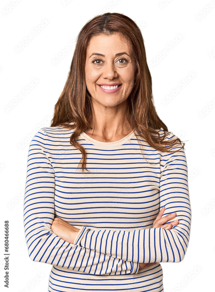 Middle-aged woman portrait in studio setting who feels confident, crossing arms with determination. Middle-aged woman portrait in studio setting who feels confident, crossing arms with determination.