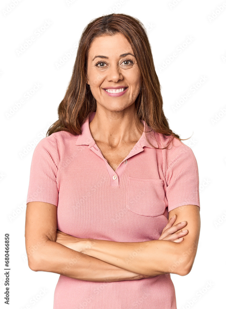 Middle-aged woman portrait in studio setting who feels confident, crossing arms with determination. Middle-aged woman portrait in studio setting who feels confident, crossing arms with determination.