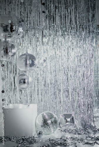 Фотография Shiny disco balls and foil fringe curtain indoors, toned in silver