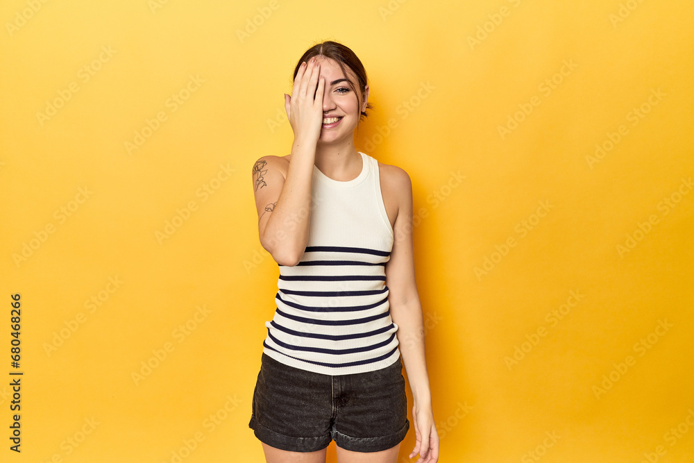 having fun covering half of face with palm. having fun covering half of face with palm.