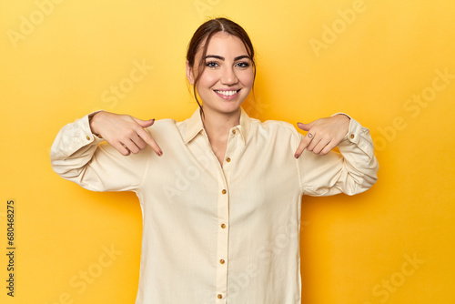 surprised pointing with finger, smiling broadly.