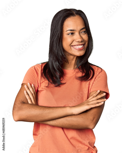 Young Filipina with long black hair in studio smiling confident with crossed arms. © Asier