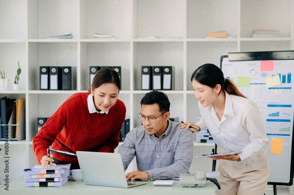 Office colleagues have a casual discussion. During a meeting in a conference room, a group of Asian business teem sit in the conference room new startup project.. Office colleagues have a casual discussion. During a meeting in a conference room, a group of Asian business teem sit in the conference room new startup project..