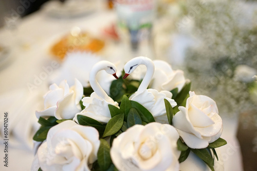 Swans made of dough decorate the wedding cake.