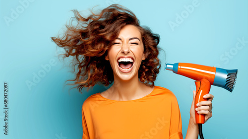 BEAUTIFUL LAUGHING WOMAN WITH LONG HAIR WITH HAIRDRYER IN STUDIO. legal AI photo