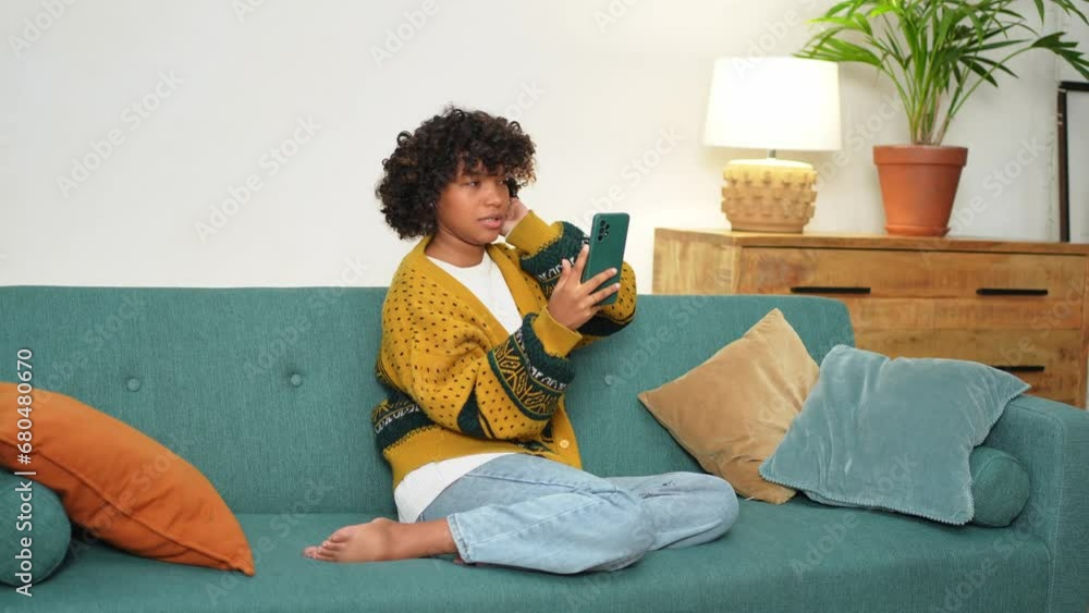 African american girl holding smartphone having video chat. Female blogger chatting with best friends in social network. Young woman having virtual meeting online chat video call at home African american girl holding smartphone having video chat. Female blogger chatting with best friends in social network. Young woman having virtual meeting online chat video call at home