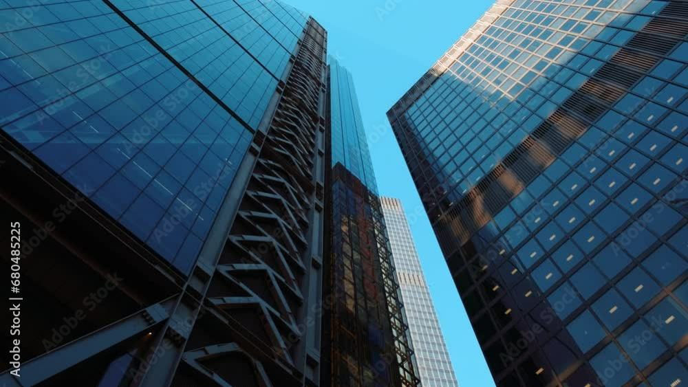 Bottom-up perspective of important and futuristic skyscrapers in the financial center of the City of London, England, UK. Great to illustrate the concept of business and trade in a large metropolis Bottom-up perspective of important and futuristic skyscrapers in the financial center of the City of London, England, UK. Great to illustrate the concept of business and trade in a large metropolis