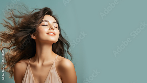 A brunette woman breathes calmly looking up isolated on pastel background photo