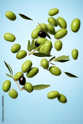 green and black olives fly in the air on blue pastel background.