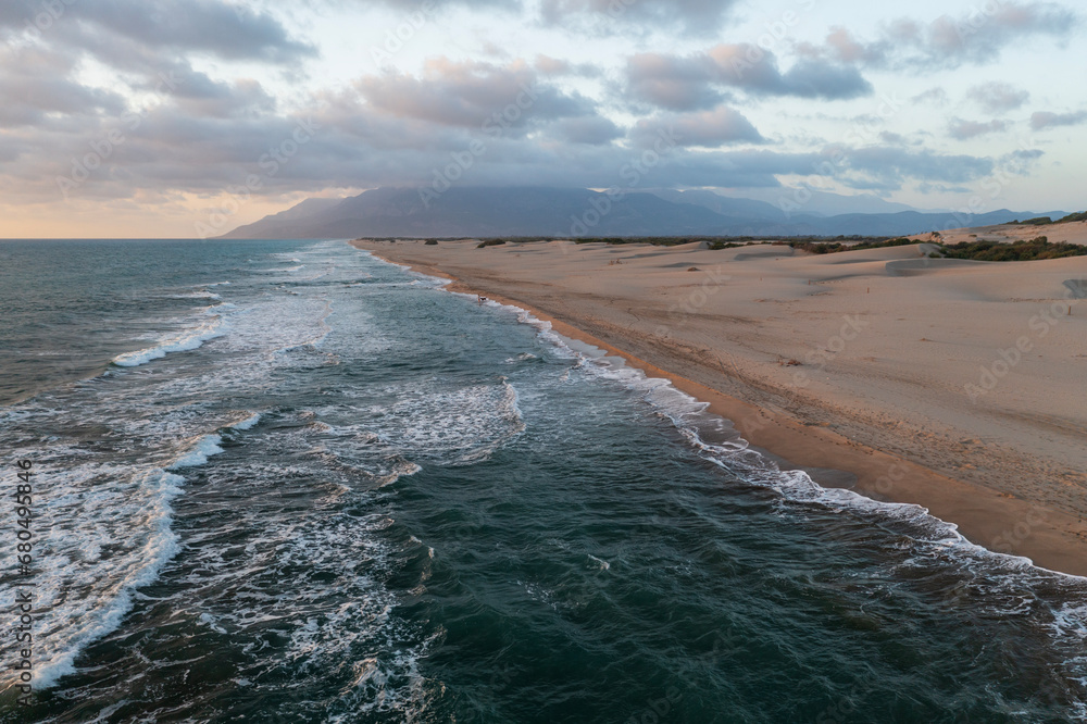 Beach and waves from top view. Turquoise water background from top view. Summer seascape with dunes from air. Top view from drone. Travel concept and idea