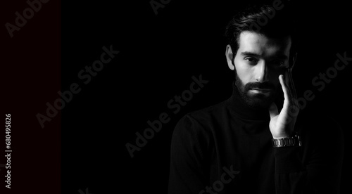 Pride thinking young business man Attractive bearded guy get confident Black and white photo Smart man stand in the dark room Confidence Cool man looking at camera copy space Business Fashion concept