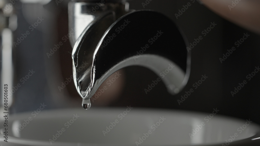 drops of water from coffee machine with double spout portafilter closeup