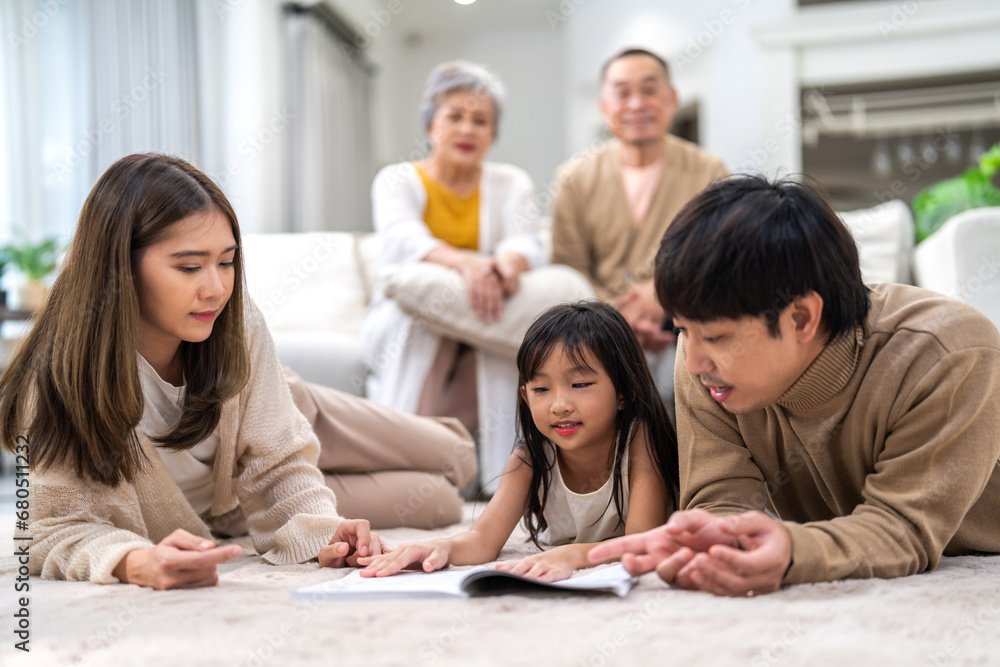 Portrait happy love asian family father and mother teach little daughter asian girl learn and study.Mom and asian young girl reading book making lessons in homeschool at home.Education Portrait happy love asian family father and mother teach little daughter asian girl learn and study.Mom and asian young girl reading book making lessons in homeschool at home.Education