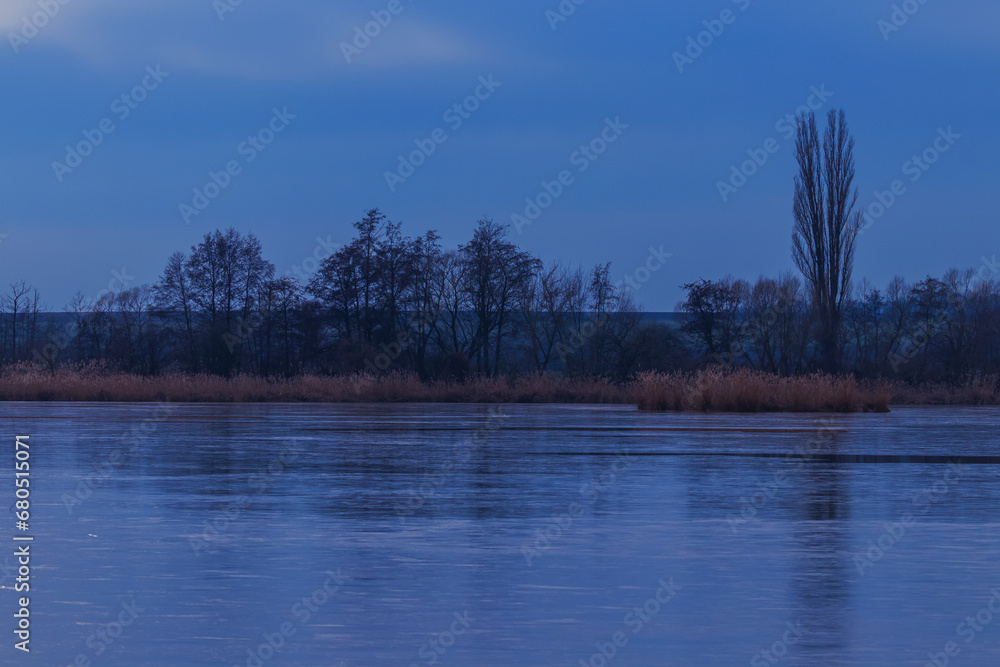 Autumn evening landscape. A pond with ice on it. Autumn evening landscape. A pond with ice on it.