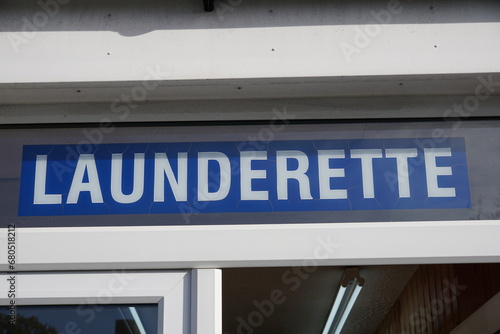 Photography launderette sign above public clothes washing service.